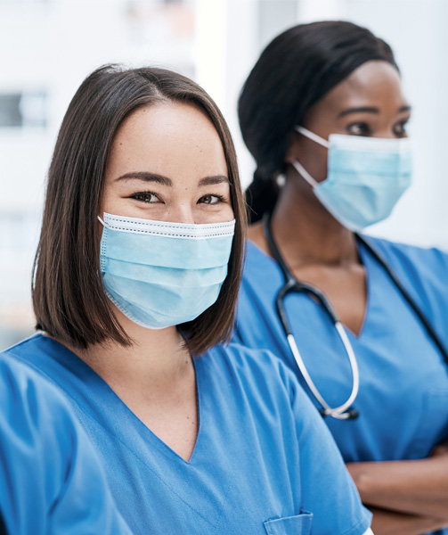 Image of two nurses wearing masks.