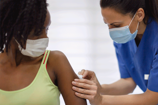 A nurse administering a vaccination.